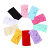 A collection of colorful nylon knit bow headbands for baby girls in shades of pink, blue, yellow, purple, and red.