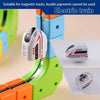 A close-up view of a magnetic train engine toy in green and orange colors, suitable for electric train play.