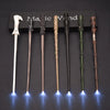 A set of five LED light-up magic wands displayed in a black box on a dark surface.