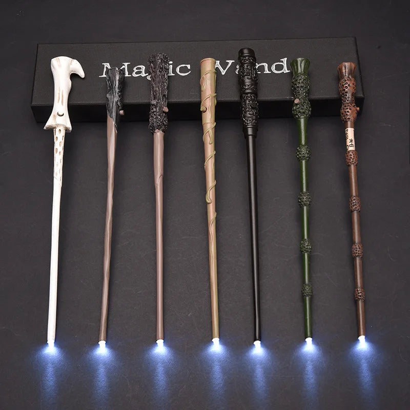 A set of five LED light-up magic wands displayed in a black box on a dark surface.