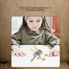 A young girl is holding a 3D metal bee and wasp puzzle on a white surface.