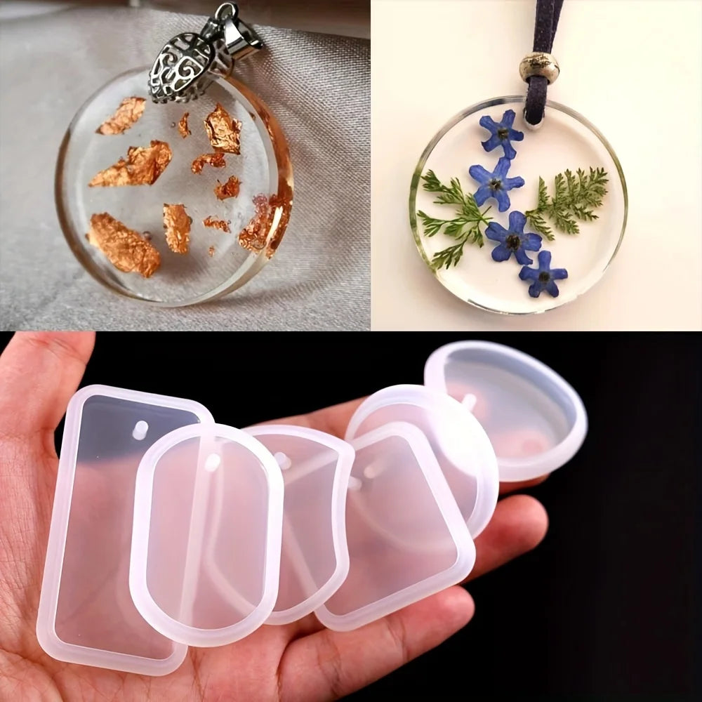 A set of silicone molds used for creating epoxy resin jewelry, including a clear mold with floral designs and several pink si