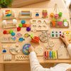 A wooden Montessori busy board for toddlers featuring various sensory activities like gears, switches, and colorful component