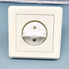 A white rotating socket safety cover for baby proofing is shown in a square plastic housing.