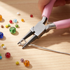 A hand uses pink pliers to grip a wire, demonstrating a jewelry making tool kit.