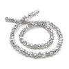 A string of clear, faceted crystal beads used for jewelry making.