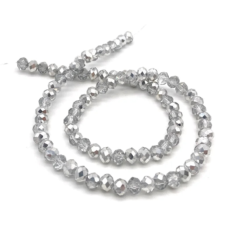 A string of clear, faceted crystal beads used for jewelry making.