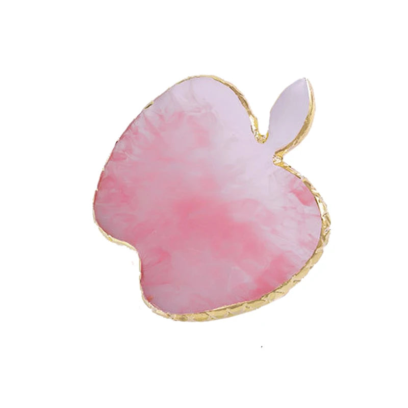 A pink watercolor apple resin nail art palette with a gold trim.