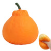 An orange stress ball with a green stem, designed for anxiety relief.
