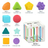 A set of colorful Montessori shape sorting cubes and a wooden box with elastic bands for sorting.