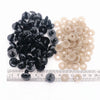 A collection of black and beige plastic safety eyes for amigurumi, including locking washers.