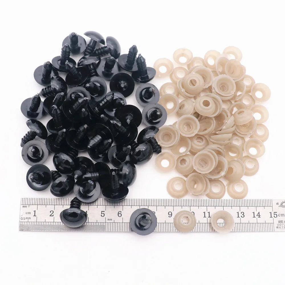 A collection of black and beige plastic safety eyes for amigurumi, including locking washers.