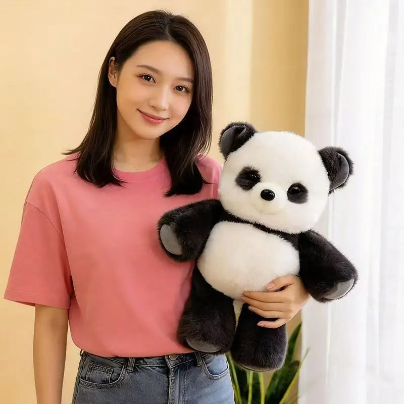 A young woman holds a black and white panda stuffed animal plushie.
