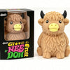 A fluffy brown Scottish Highland cow squishy toy in its packaging box.