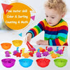 A toddler is sorting colorful plastic dinosaurs into various colored bowls for fine motor skill development.