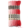 A set of six skeins of vibrant embroidery thread in various shades of pink and red for cross stitch and DIY crafts