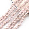 A string of light pink heart-shaped acrylic beads is displayed on a white background.