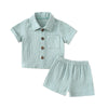 A baby boy outfit set featuring a light mint green textured linen shirt and matching shorts.
