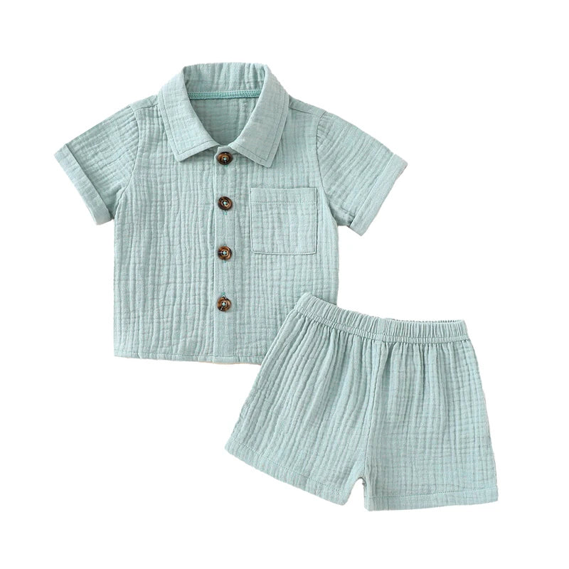 A baby boy outfit set featuring a light mint green textured linen shirt and matching shorts.