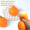 A hand holds a soft, orange stress ball next to a flat plate with a black grid pattern.