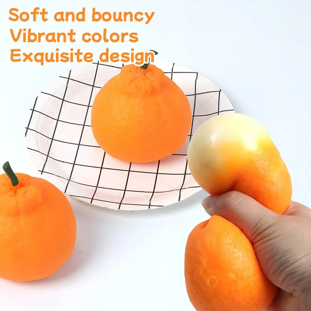 A hand holds a soft, orange stress ball next to a flat plate with a black grid pattern.