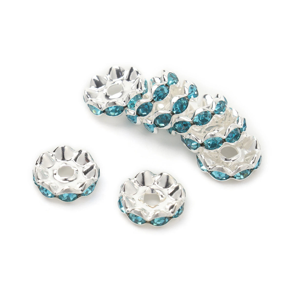 A collection of silver spacer beads featuring blue crystal rhinestones for jewelry making.