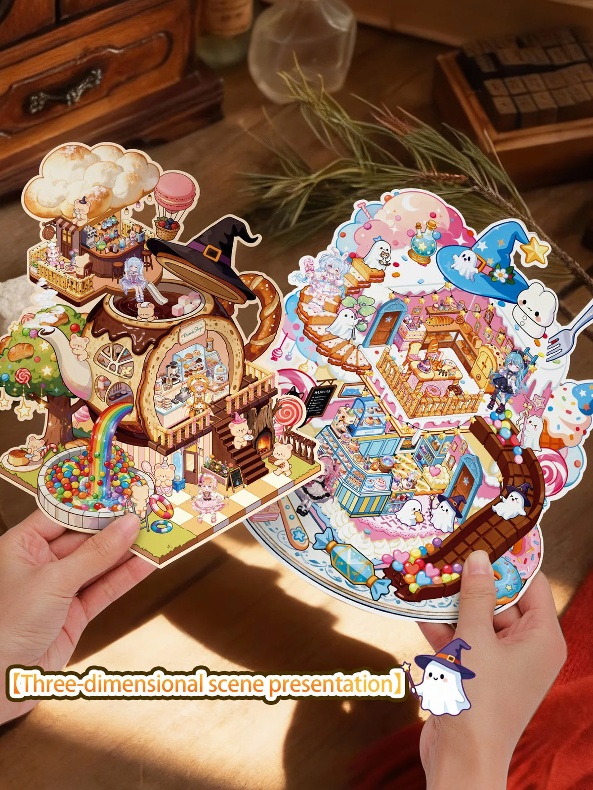 A hand holds a colorful sticker set featuring three-dimensional scenes of whimsical houses and characters.