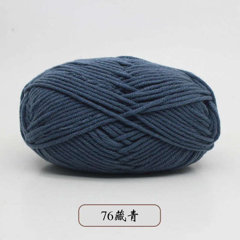 A ball of dark blue pre-dyed milk cotton yarn, labeled as 76-count thread, shown from the side.