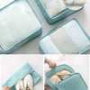Light blue travel packing cubes and storage bags with white accents shown in various angles