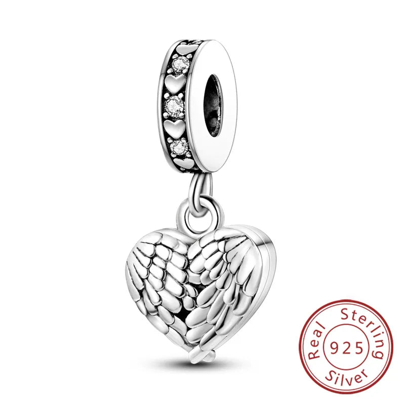 A sterling silver heart charm bead with a textured design and a bail for bracelets.
