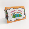An orange flashcard with a scalloped white border featuring colorful illustrations of children and the text Verb Tense