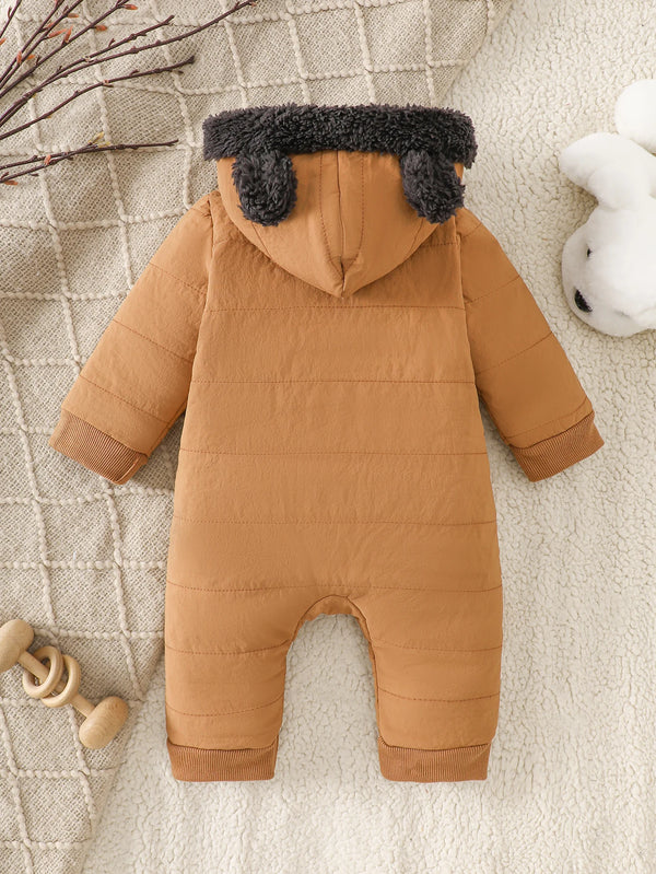 A brown fleece romper for infants with gray faux fur trim lying on a cream textured blanket.