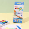 A box of six triangle plastic crayons with a green and blue tip is shown next to a white paper and a blue crayon.
