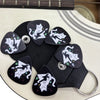 A set of six decorative guitar picks with a keychain holster in black and white designs.