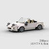 A white classic rally car model built from building blocks, shown in a side view.