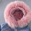 A denim jacket with a fluffy pink faux fur collar is displayed against a gray background.