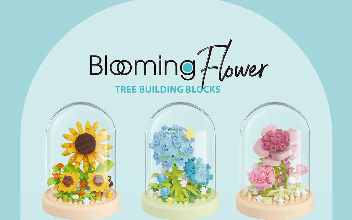 Three glass-encased flower building blocks in yellow, blue, and pink colors.