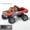 An orange and red alloy remote control off-road truck with a black remote and battery visible.
