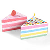 A pink and multicolored striped gift box cake decorated with a red dot on top and a candle.