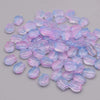 A pile of iridescent pink and blue tulip flower glass beads.