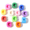A collection of colorful acrylic alphabet beads shaped like the letter G in various shades of pink, green, blue, yellow, and 