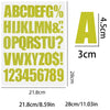 A sheet of DIY iron-on heat transfer patches showing the alphabet and numbers in a light yellow color with size indicators.