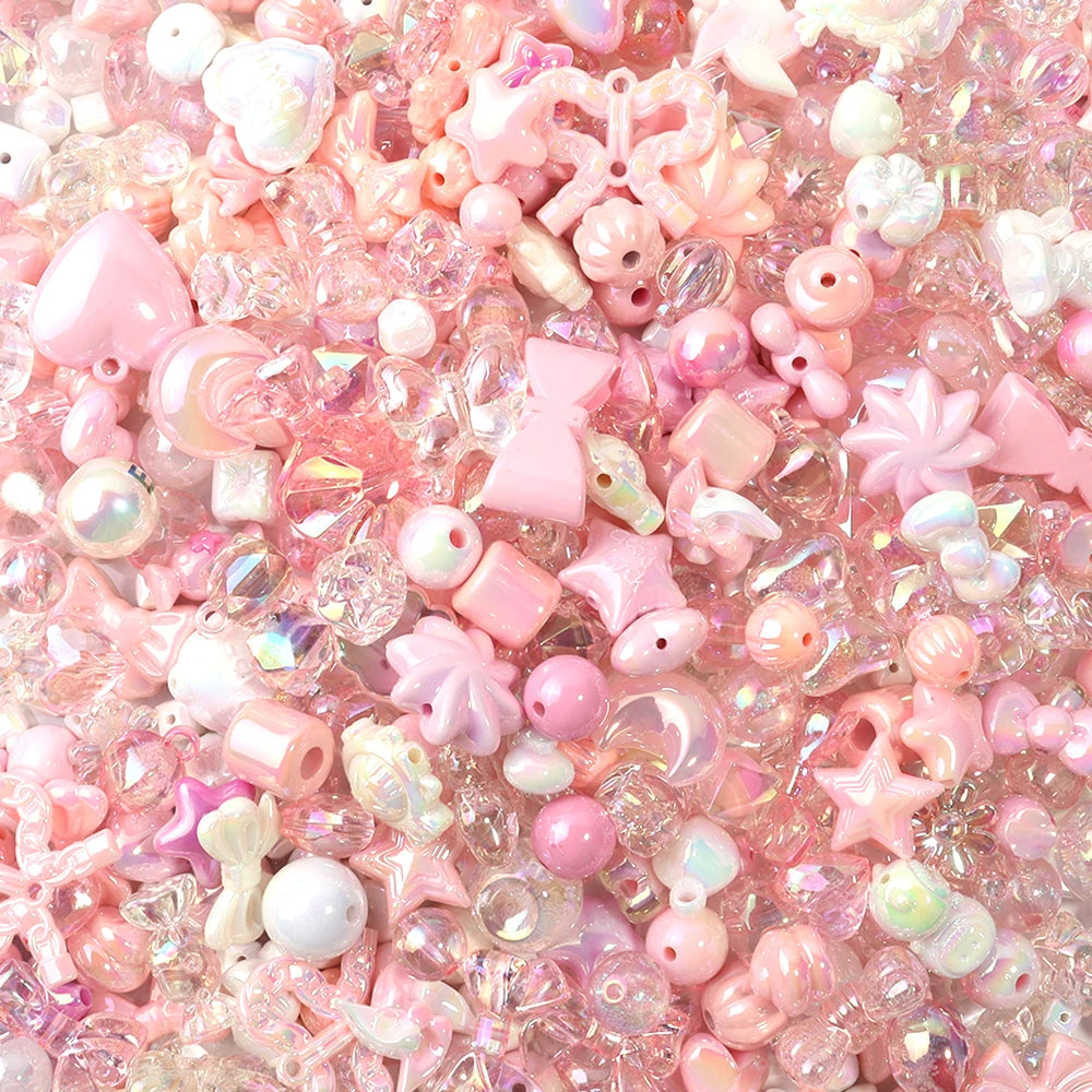 A close-up of pink and iridescent acrylic bow beads for DIY jewelry making