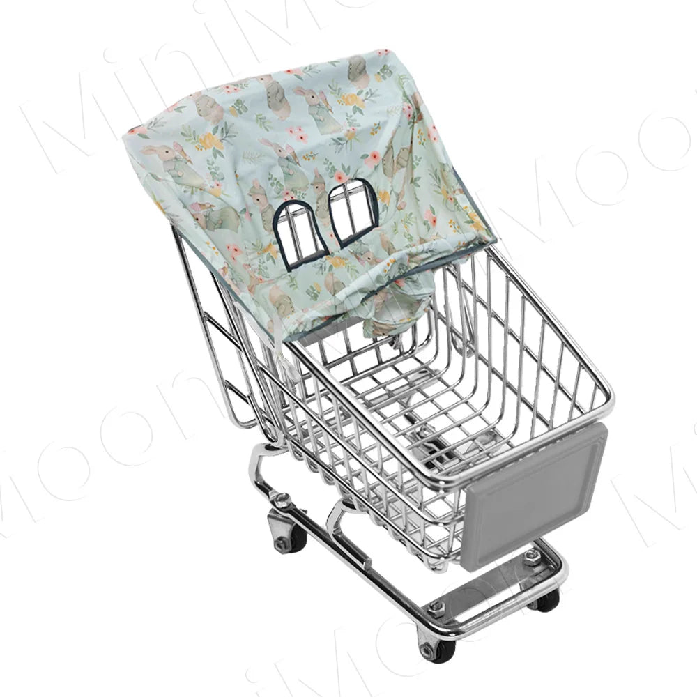 Silver shopping cart with a floral patterned light blue seat cover and wheels