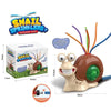 A brown cartoon snail sprinkler toy with green accents and a water nozzle, packaged in a box.