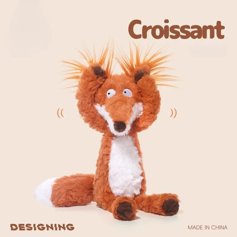A fluffy orange and white fox plushie toy with spiky ears sitting on a light background.