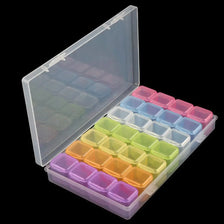 A clear plastic storage box for diamond painting supplies with multiple colored organizer trays.