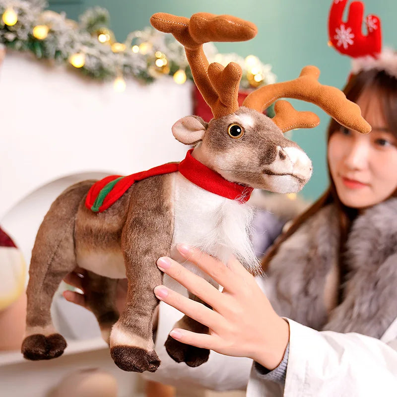 A woman is holding a soft plush reindeer Christmas stuffed animal with brown antlers and a red collar.