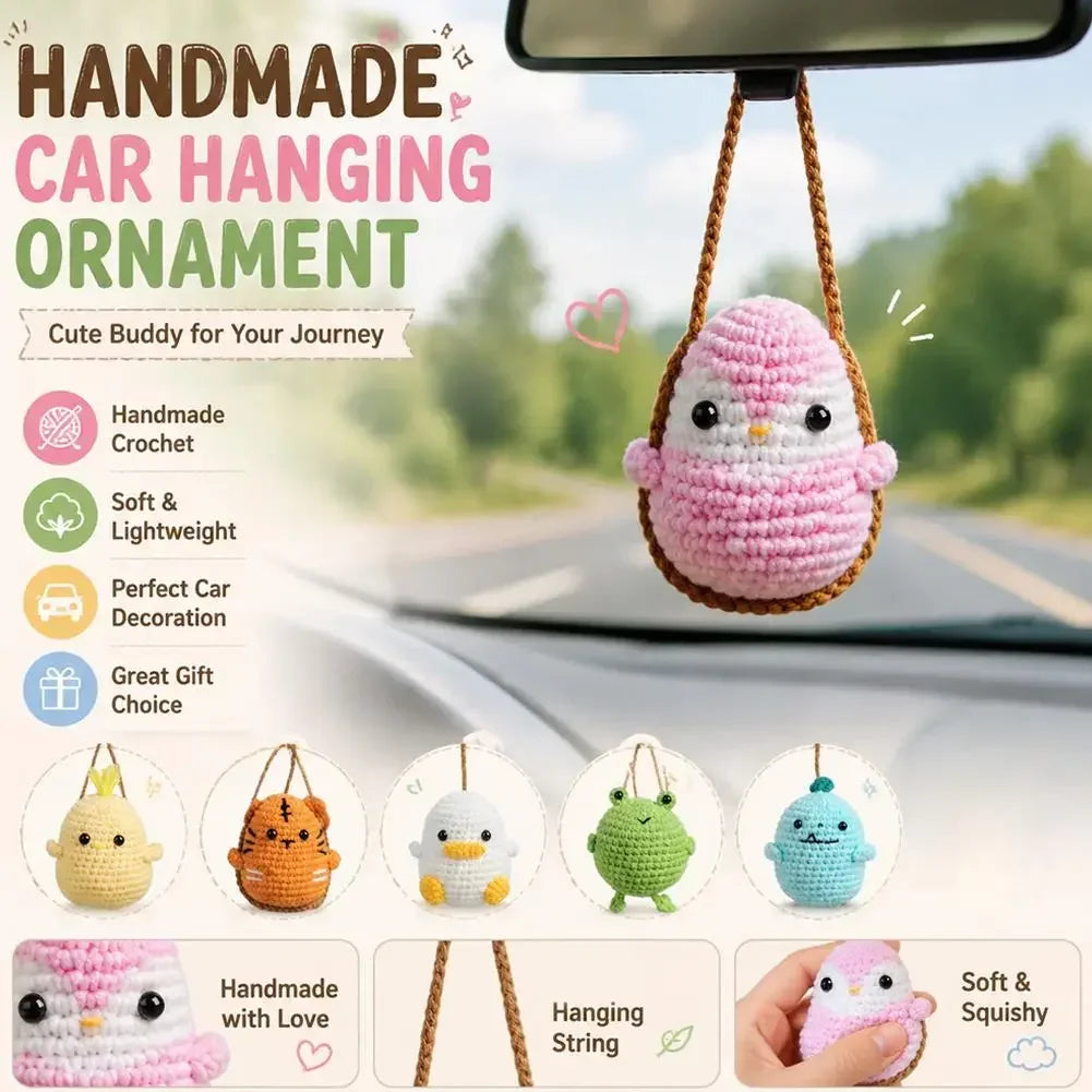 A handmade crochet pink owl ornament hanging from a string, displayed in a car interior setting.