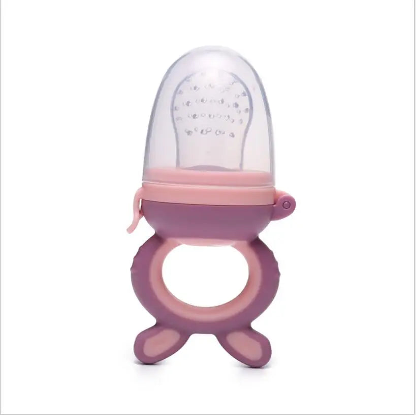 A silicone baby food feeder with a clear dome and pink silicone teether.